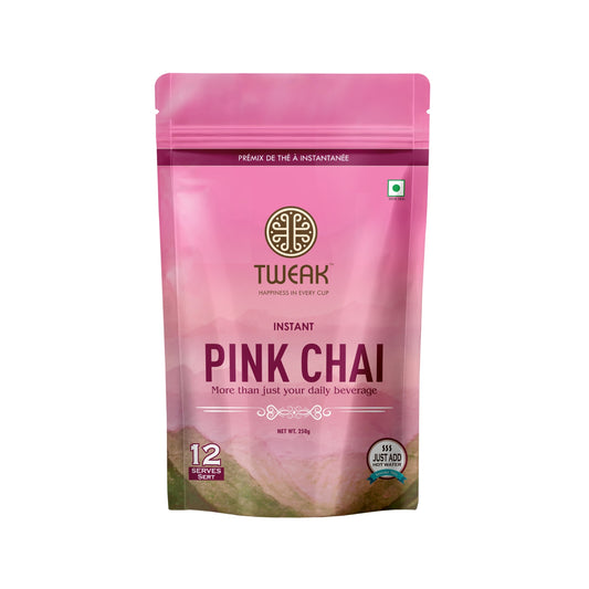 A creamy, pink cup of traditional Kashmiri chai topped with crushed nuts